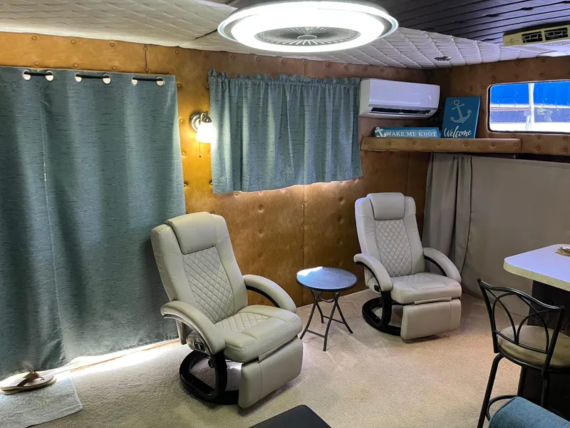 Slide: The Image of Interior of a 1987 Sumerset Custom houseboat with modern seating and decor. - 12