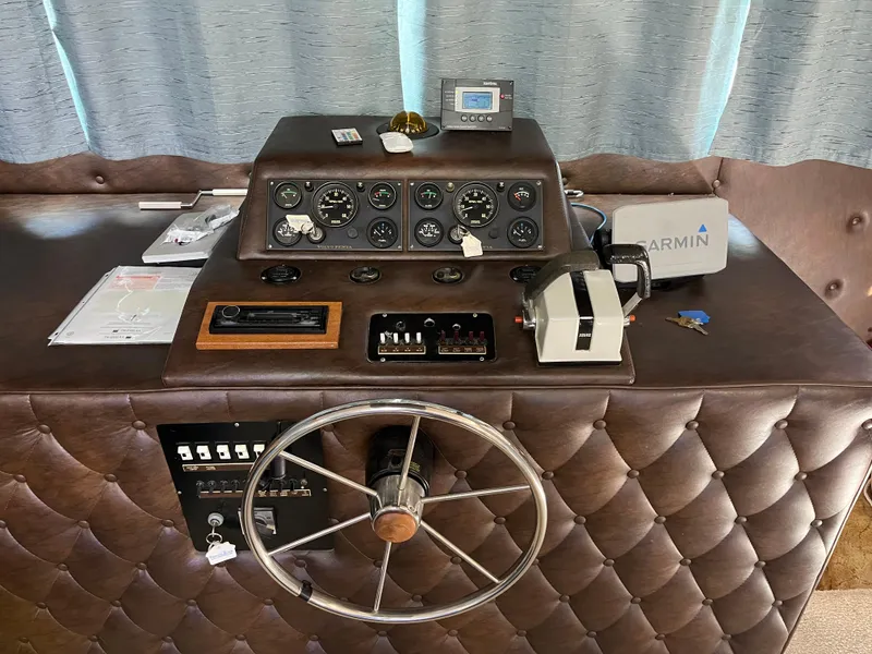Slide: The Image of 1987 Sumerset Custom boat helm with steering wheel, gauges, and Garmin device. - 14