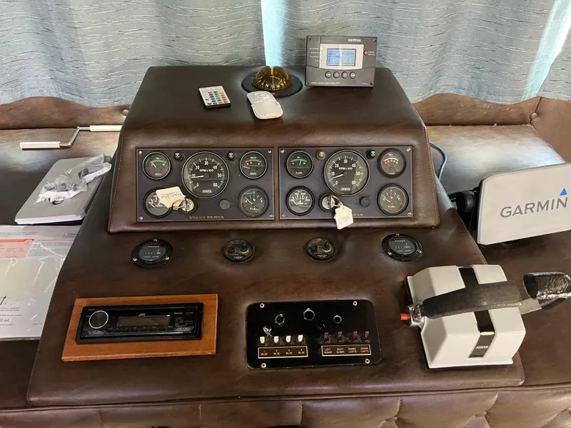 Slide: The Image of 1987 Sumerset Custom boat dashboard with gauges, controls, and Garmin device. - 15