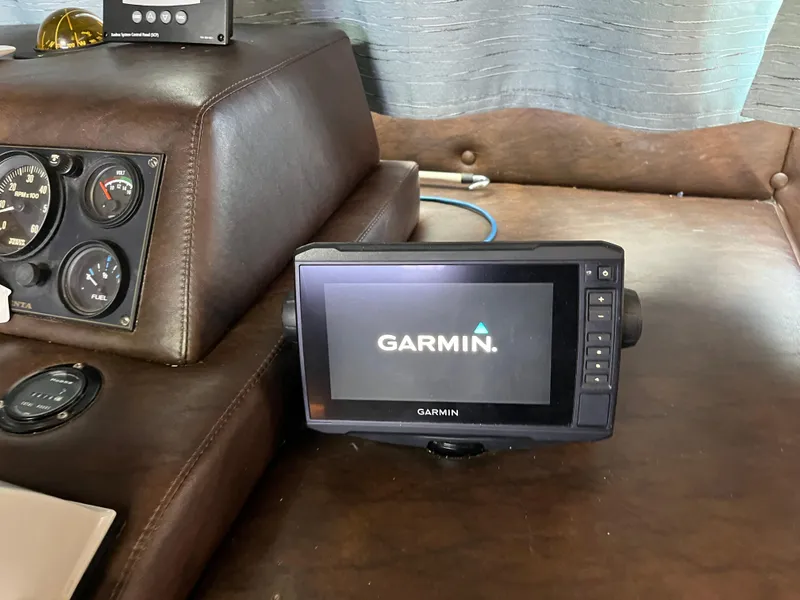 Slide: The Image of Garmin device on 1987 Sumerset Custom boat dashboard with gauges. - 16