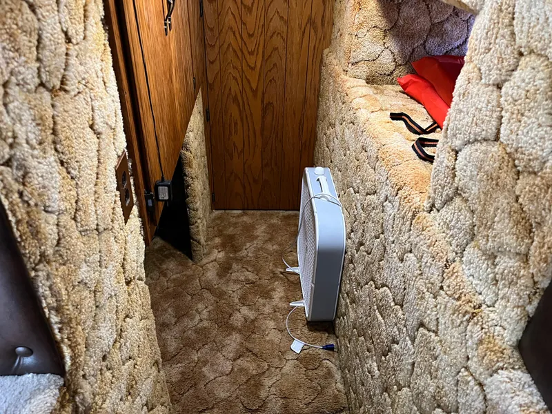 Slide: The Image of 1987 Sumerset Custom interior with beige carpet, wooden door, and a portable fan. - 20