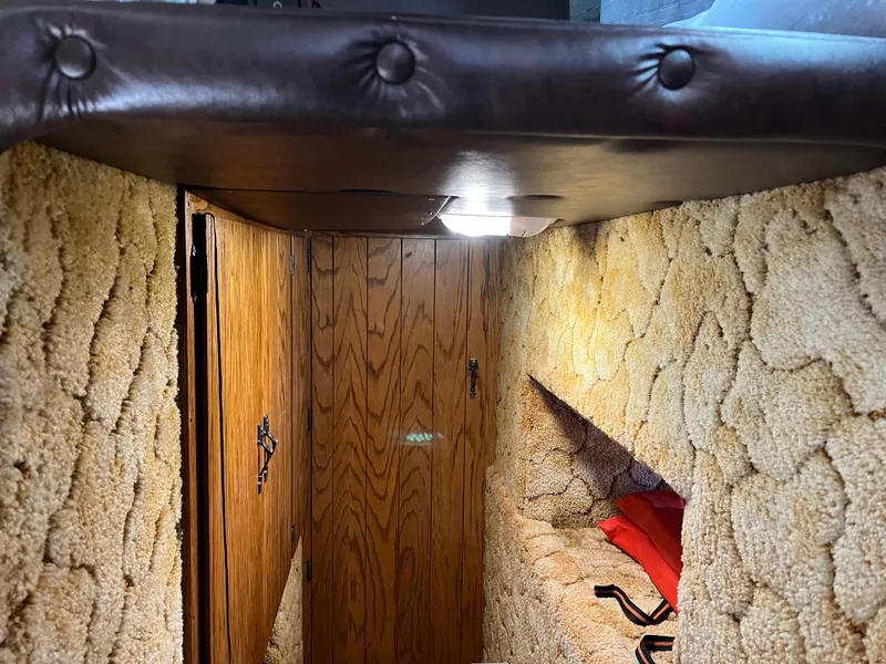 Slide: The Image of Interior of a 1987 Sumerset Custom houseboat with wood paneling and plush carpeting. - 21