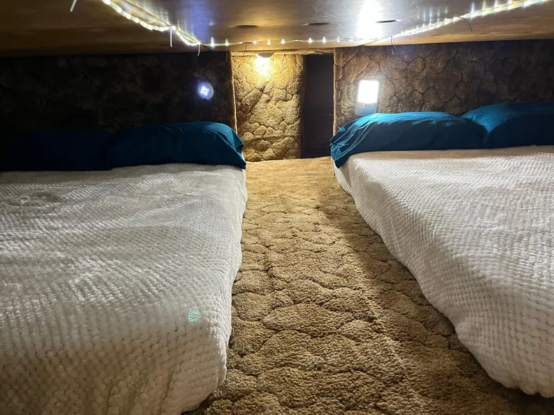 Slide: The Image of Cozy 1987 Sumerset Custom interior with two beds, warm lighting, and textured walls. - 22