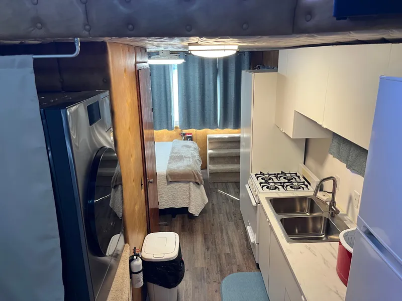 Slide: The Image of Compact 1987 Sumerset Custom interior with kitchen, bed, and appliances. Cozy and efficient layout. - 25
