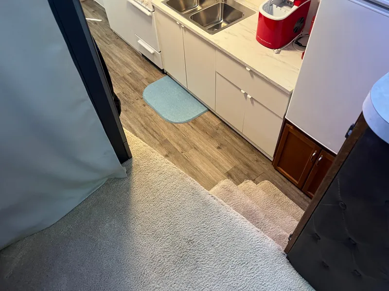 Slide: The Image of Interior view of 1987 Sumerset Custom houseboat kitchen with wooden flooring and carpeted stairs. - 27