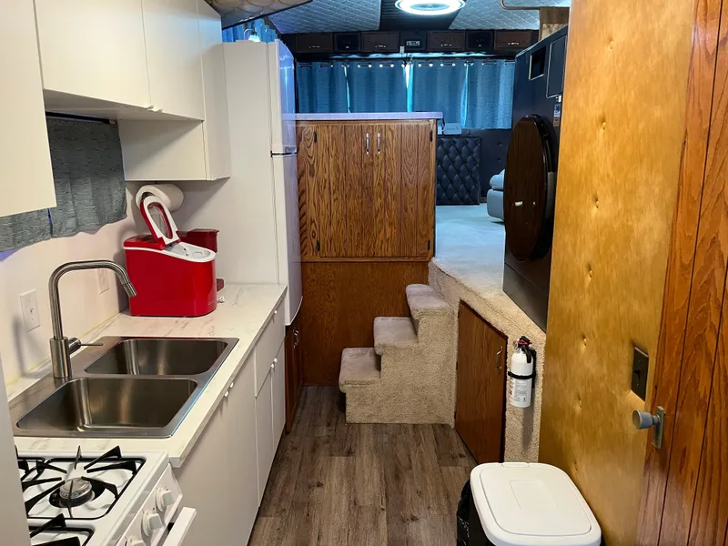 Slide: The Image of Interior of a 1987 Sumerset Custom houseboat with kitchen and stairs. - 29