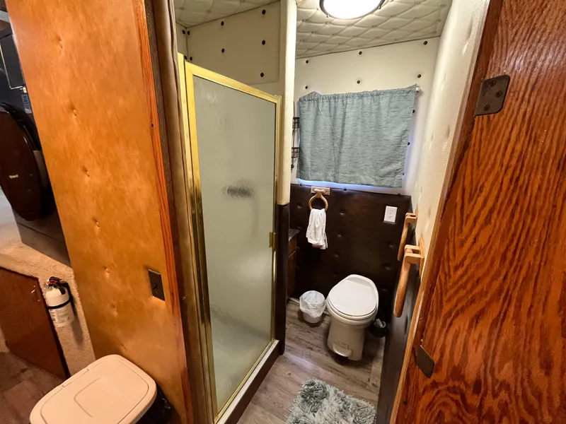 Slide: The Image of 1987 Sumerset Custom bathroom with shower, toilet, and wood accents. - 32