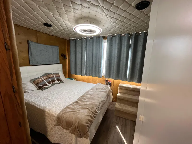 Slide: The Image of Cozy bedroom in 1987 Sumerset Custom houseboat with modern decor and soft lighting. - 34