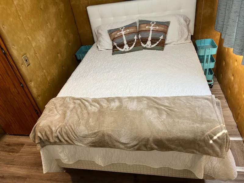 Slide: The Image of Cozy bedroom with nautical-themed pillows in a 1987 Sumerset Custom houseboat. - 35