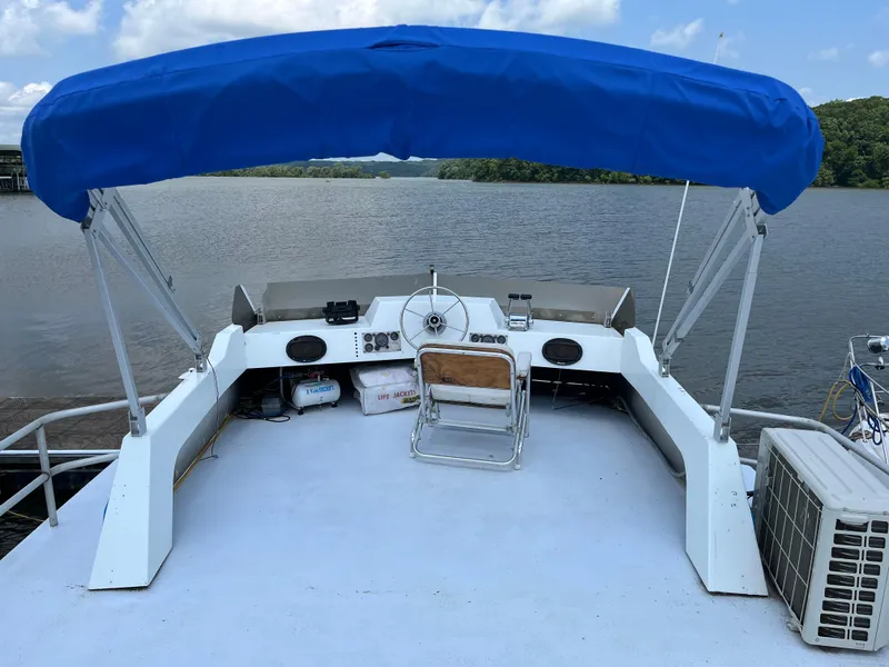 Slide: The Image of 1987 Sumerset Custom boat with blue canopy on a serene lake. - 7