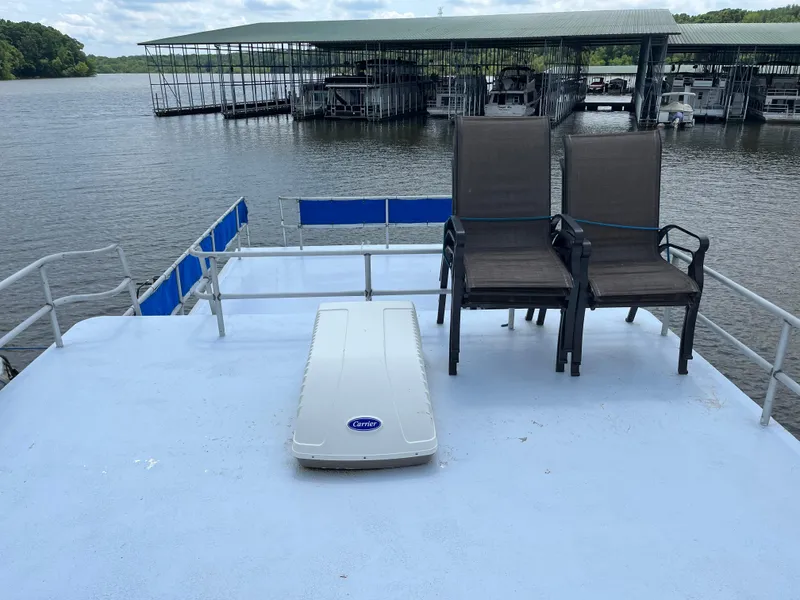 Slide: The Image of 1987 Sumerset Custom houseboat deck with chairs, overlooking marina and water. - 9