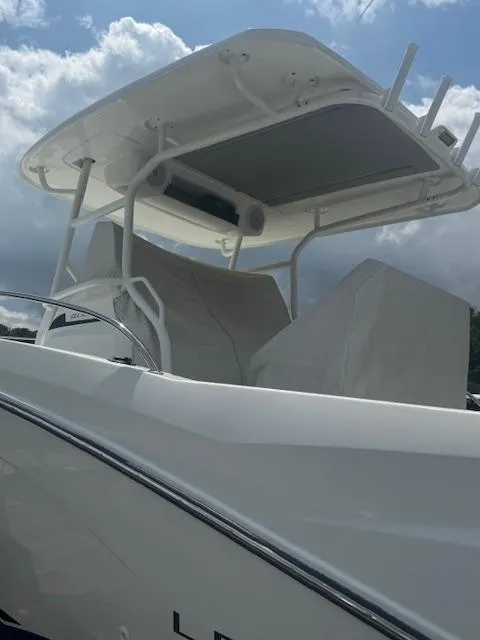 Slide: The Image of 2020 Jeanneau Leader 9.0 CC boat with sleek design under a cloudy sky. - 10
