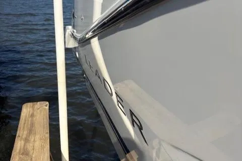 Slide: The Image of 2020 Jeanneau Leader 9.0 CC boat docked by the water. - 11