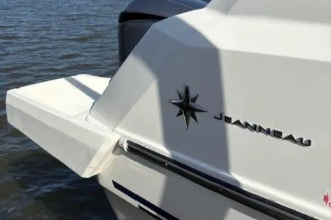 Slide: The Image of 2020 Jeanneau Leader 9.0 CC boat stern with logo, on water. - 13