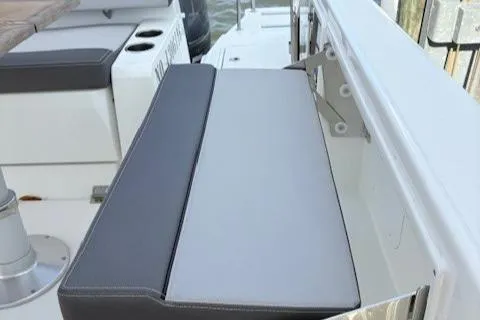 Slide: The Image of 2020 Jeanneau Leader 9.0 CC boat seating area with gray cushions. - 18