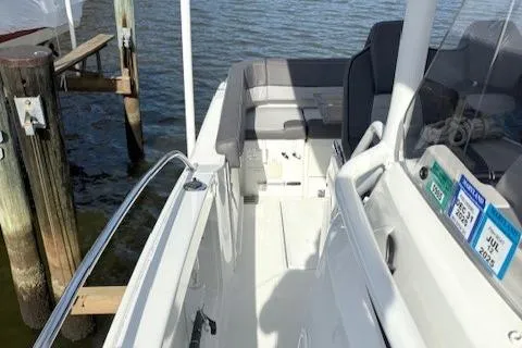 Slide: The Image of 2020 Jeanneau Leader 9.0 CC boat docked, featuring sleek white deck and seating area. - 21