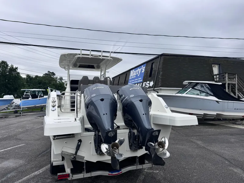 Slide: The Image of 2020 Jeanneau Leader 9.0 CC boat with dual outboard engines in a marina. - 5