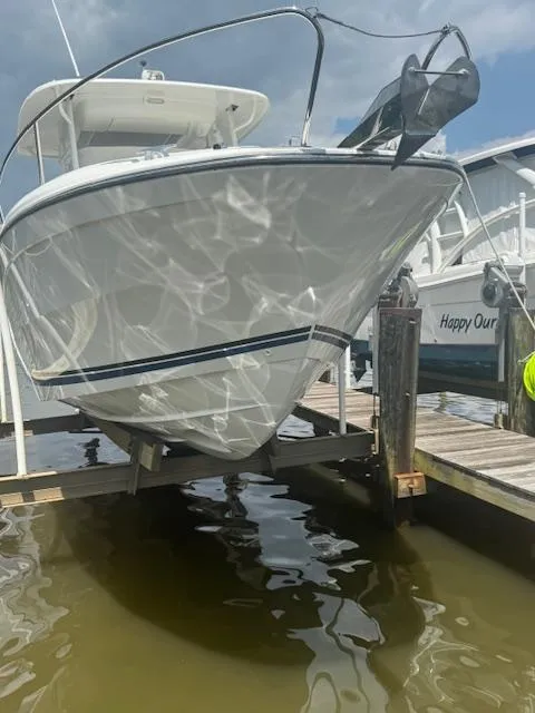 Slide: The Image of 2020 Jeanneau Leader 9.0 CC boat docked, reflecting sunlight on water. - 8