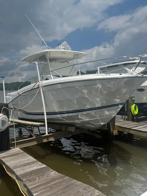 Slide: The Image of 2020 Jeanneau Leader 9.0 CC boat docked under cloudy sky. - 9