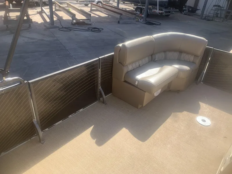 Slide: The Image of 2017 Lexington LML boat interior with beige seating and open deck area. - 2