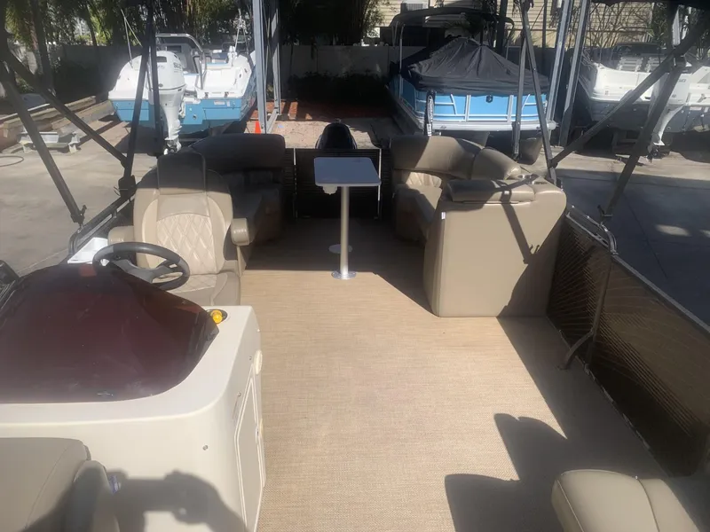 Slide: The Image of 2017 Lexington LML pontoon boat interior with beige seating and steering console. - 4
