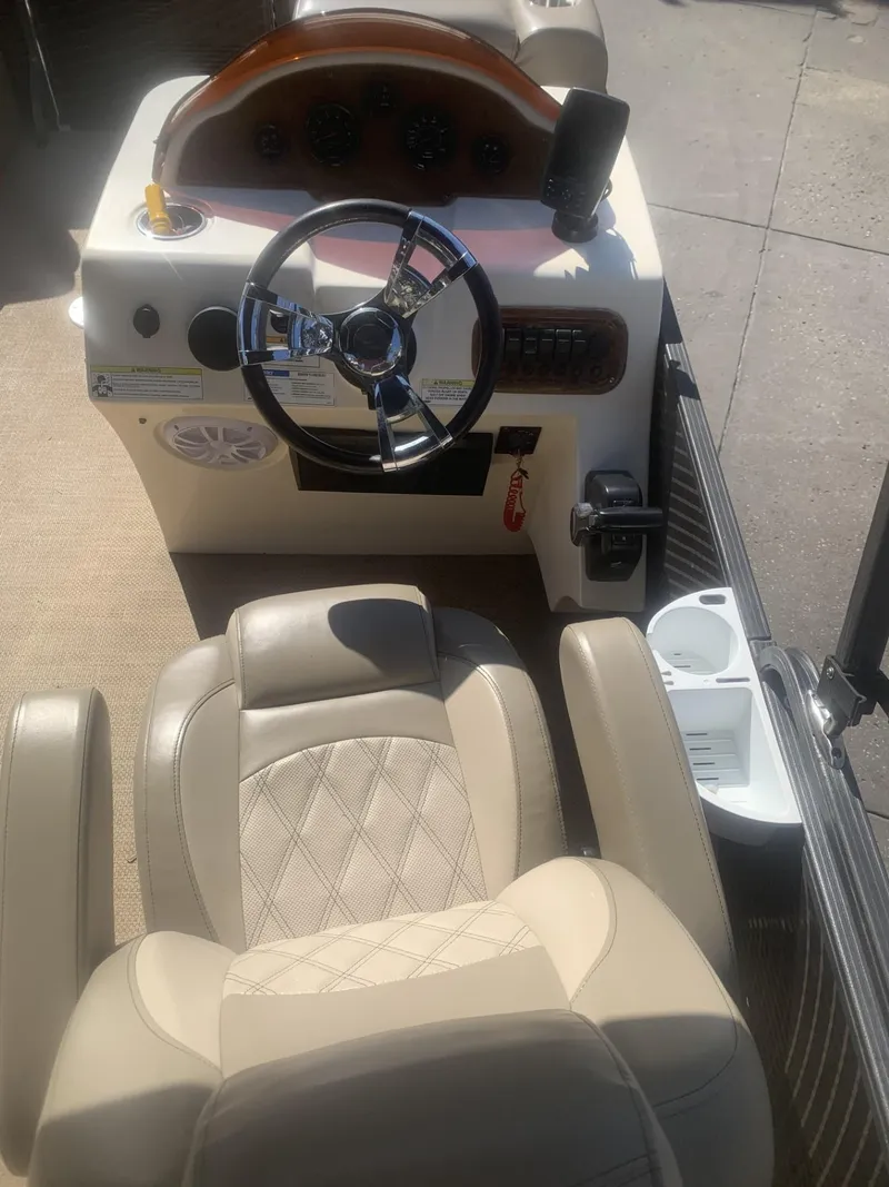 Slide: The Image of 2017 Lexington LML boat interior with steering wheel and beige seating. - 8