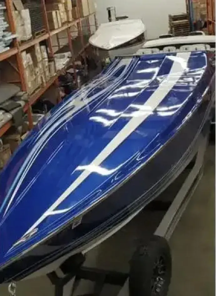 Slide: The Image of 1989 Cigarette 35 Cafe Racer boat with sleek blue and white design in storage. - 11