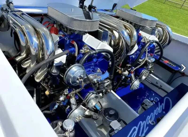 Slide: The Image of Twin engines of a 1989 Cigarette 35 Cafe Racer with chrome details. - 12