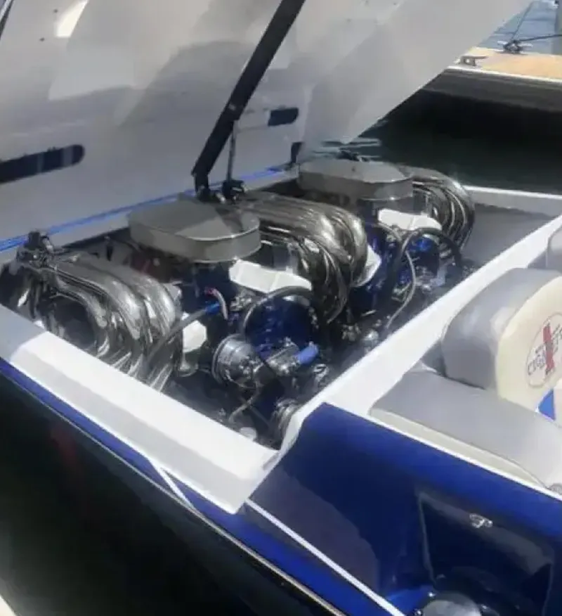 Slide: The Image of 1989 Cigarette 35 Cafe Racer boat engine compartment with dual engines, open hatch. - 13