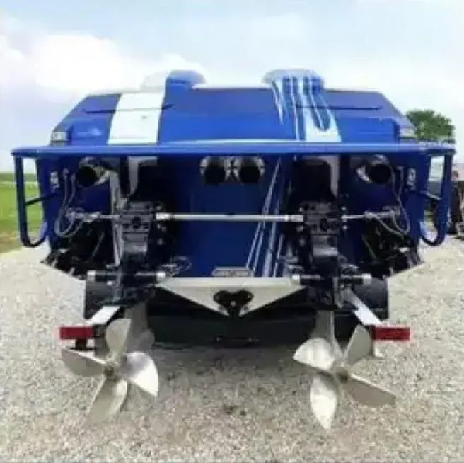 Slide: The Image of 1989 Cigarette 35 Cafe Racer boat, rear view with dual propellers, blue and white design. - 14