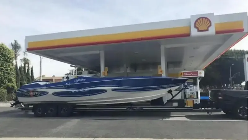 Slide: The Image of 1989 Cigarette 35 Cafe Racer boat on trailer at Shell gas station. - 15