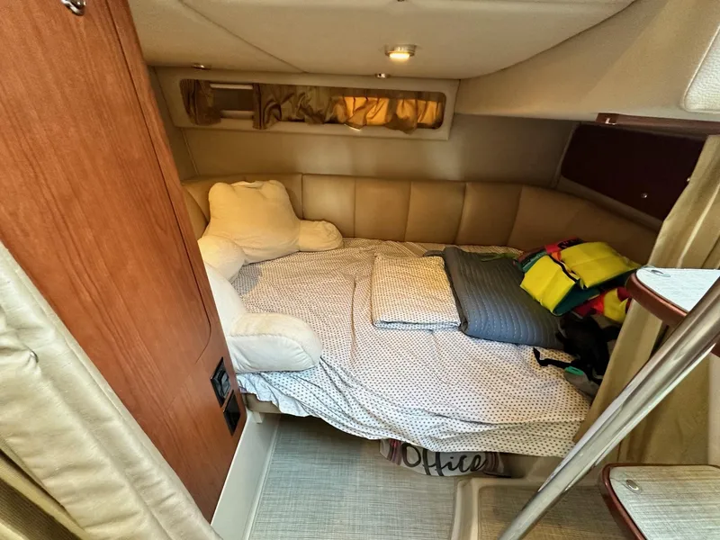 Slide: The Image of 2004 Chaparral Signature 310 cabin interior with cozy bed and soft lighting. - 12