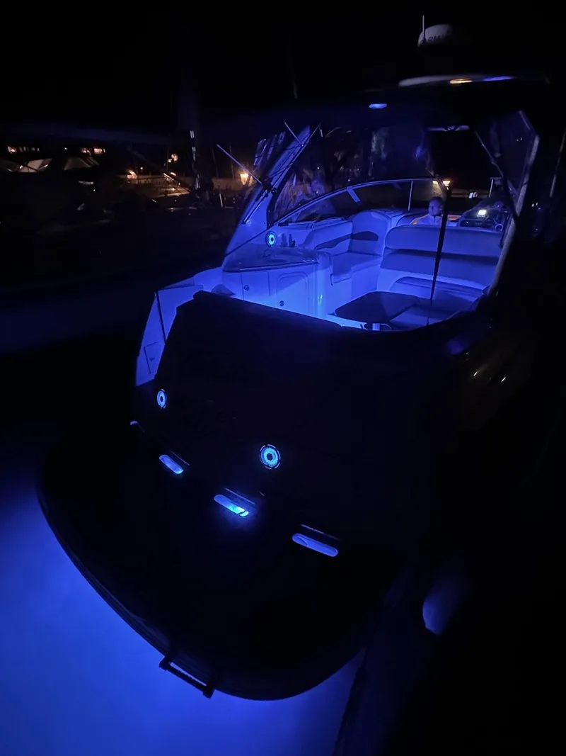 Slide: The Image of 2004 Chaparral Signature 310 boat with blue LED lights at night. - 3