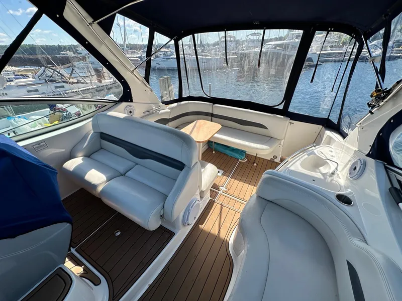 Slide: The Image of 2004 Chaparral Signature 310 boat interior with seating and table, docked at marina. - 4