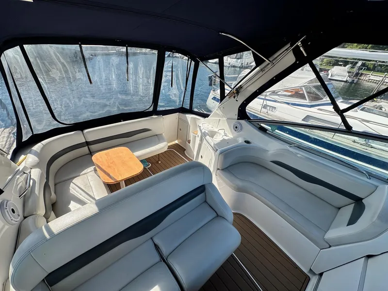 Slide: The Image of 2004 Chaparral Signature 310 boat interior with seating and table, docked at marina. - 5