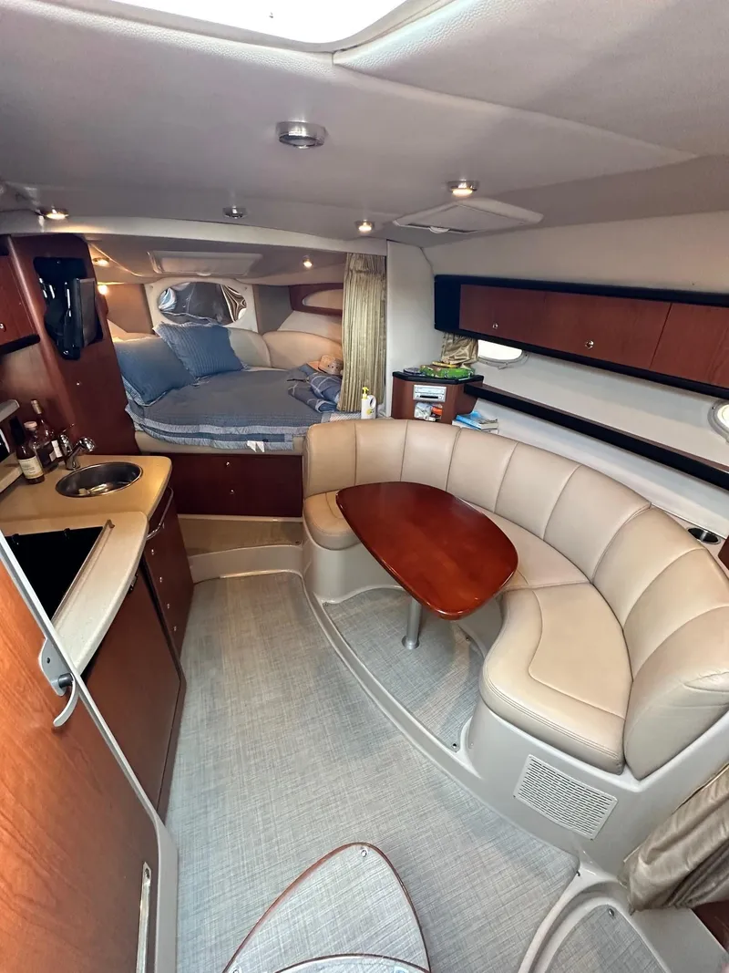 Slide: The Image of 2004 Chaparral Signature 310 interior with kitchen, seating, and sleeping area. - 8