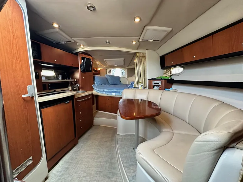 Slide: The Image of 2004 Chaparral Signature 310 cabin interior with kitchenette, seating, and sleeping area. - 9