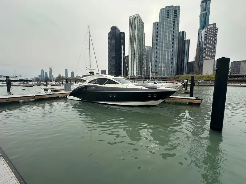Slide: The Image of Luxury 2008 Marquis 40 SC yacht docked in urban marina with skyscrapers in background. - 12