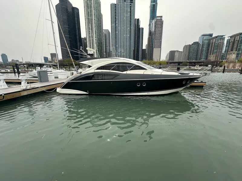 Slide: The Image of 2008 Marquis 40 SC yacht docked in urban marina with skyscrapers in background. - 2