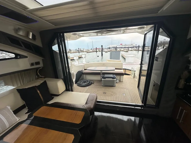 Slide: The Image of Interior view of 2008 Marquis 40 SC yacht with open deck and marina backdrop. - 4