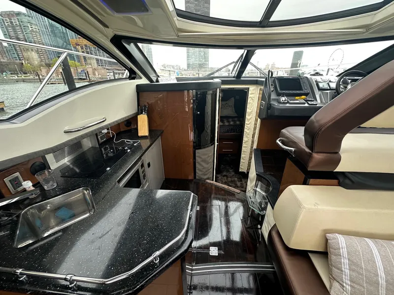 Slide: The Image of Interior of a 2008 Marquis 40 SC yacht with modern kitchen and seating area. - 7