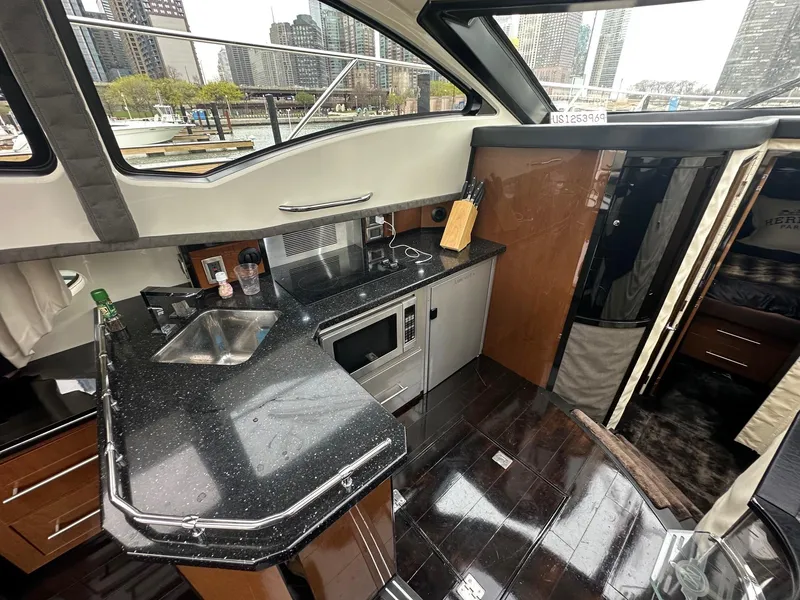 Slide: The Image of Interior of a 2008 Marquis 40 SC yacht with modern kitchen amenities. - 8