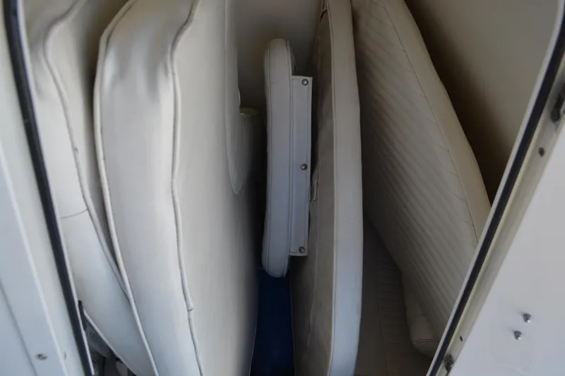 Slide: The Image of Cushions stored inside a 2006 Boston Whaler 220 Dauntless boat compartment. - 10