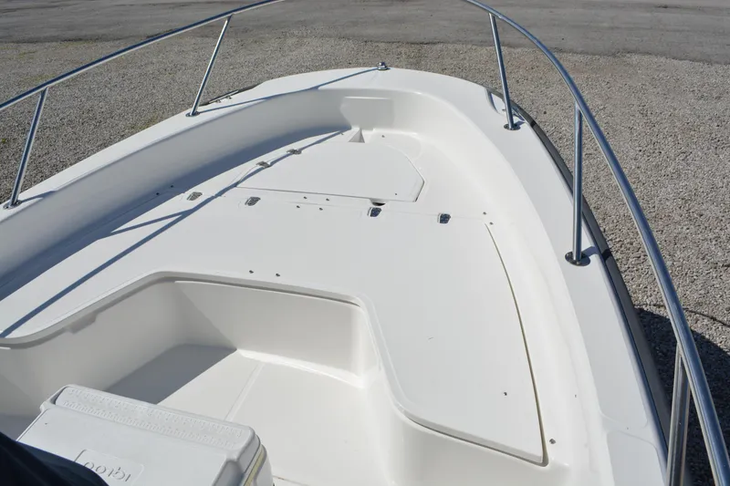 Slide: The Image of 2006 Boston Whaler 220 Dauntless boat deck with stainless steel railings. - 7