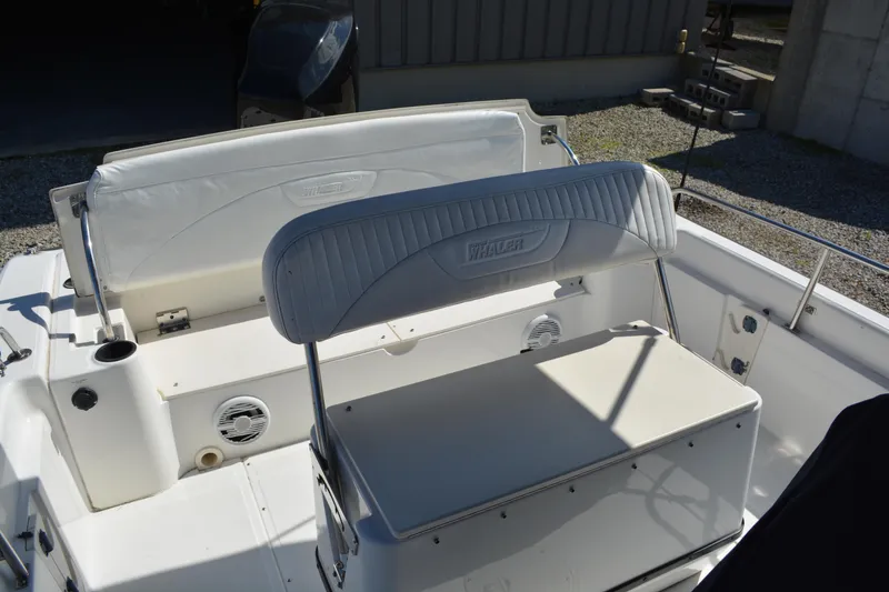 Slide: The Image of 2006 Boston Whaler 220 Dauntless boat interior with seating and storage. - 8