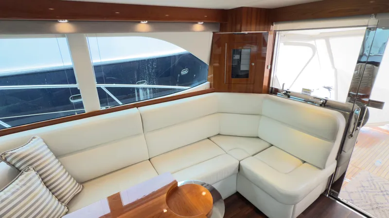 Slide: The Image of Luxurious interior of 2011 Riviera 43 IPS Open Flybridge with white leather seating. - 6