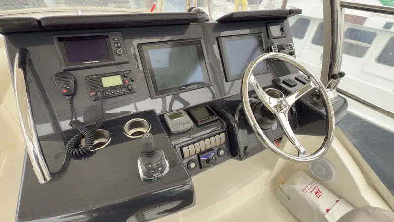 Slide: The Image of Helm of 2011 Riviera 43 IPS Open Flybridge with modern navigation equipment and controls. - 16