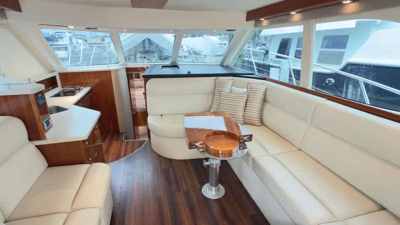 Slide: The Image of Luxurious interior of 2011 Riviera 43 IPS Open Flybridge with plush seating and wooden flooring. - 3