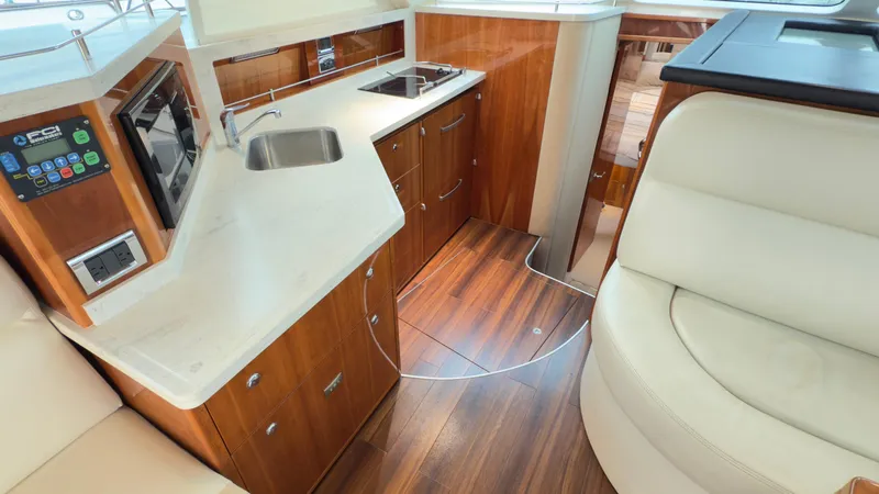 Slide: The Image of Luxurious 2011 Riviera 43 IPS Open Flybridge yacht interior with modern kitchen and seating. - 4