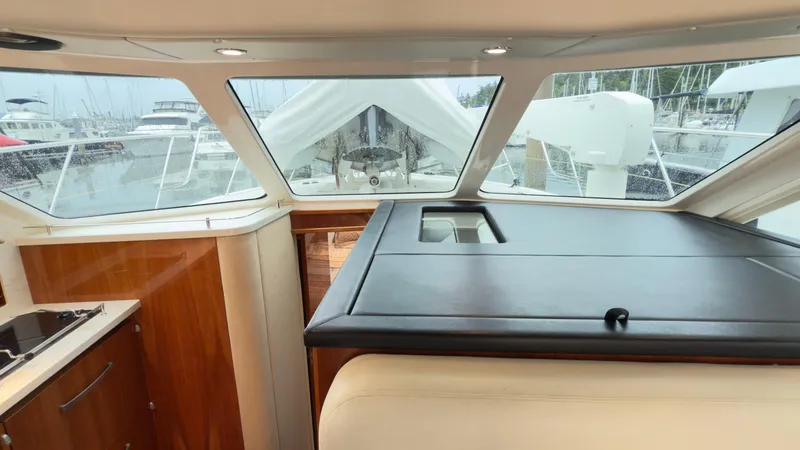 Slide: The Image of Interior view of 2011 Riviera 43 IPS Open Flybridge yacht with marina backdrop. - 5
